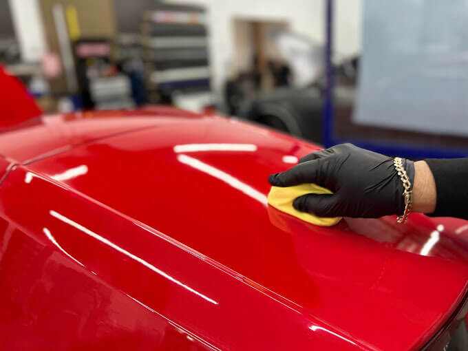 Polar Tint Henderson Certified technician applying 3M ceramic coating over paint protection film on a luxury vehicle